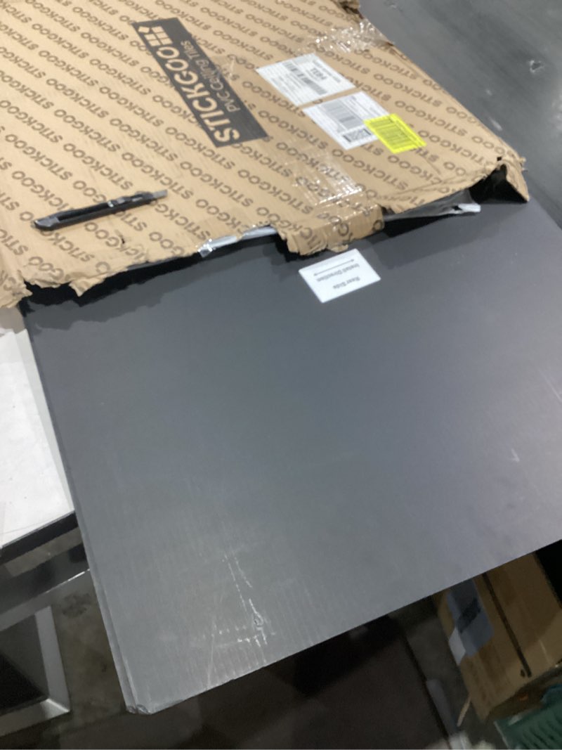 Condition photo showing As Is for STICKGOO Black Drop Ceiling Tiles 2ft x 2ft, Waterproof PVC Ceiling Panels, Fire Resistant and Washable Smooth Ceilings Decor Coverings 24 x 24in - 12 Pack Cover 48 Sq. Ft Black 12 Pack of 2ft x 2ft