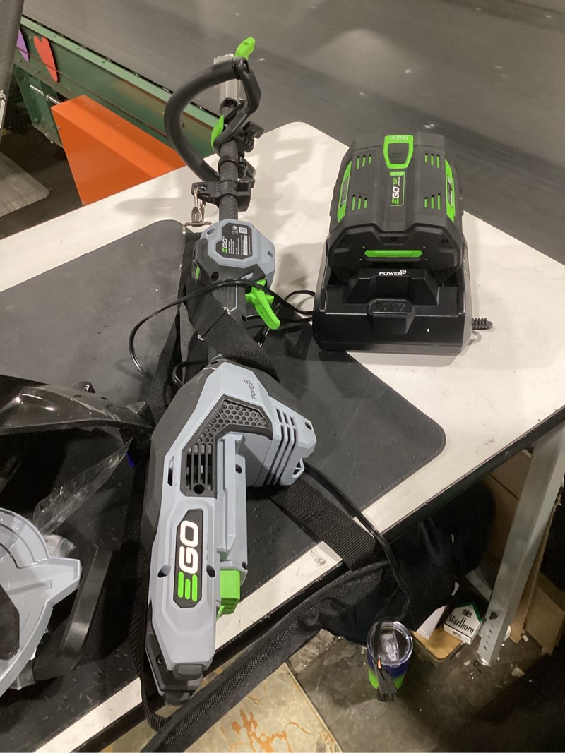 Condition photo showing As Is for ego power+ mhc1603 multi-head combo kit 16-inch 56-volt carbon fiber string trimmer with powerload & 8-inch carbon fiber edger attachment & 56-volt power head, 4.0ah battery and 320w charger included combo carbon fiber combo kit, w/4.0ah battery