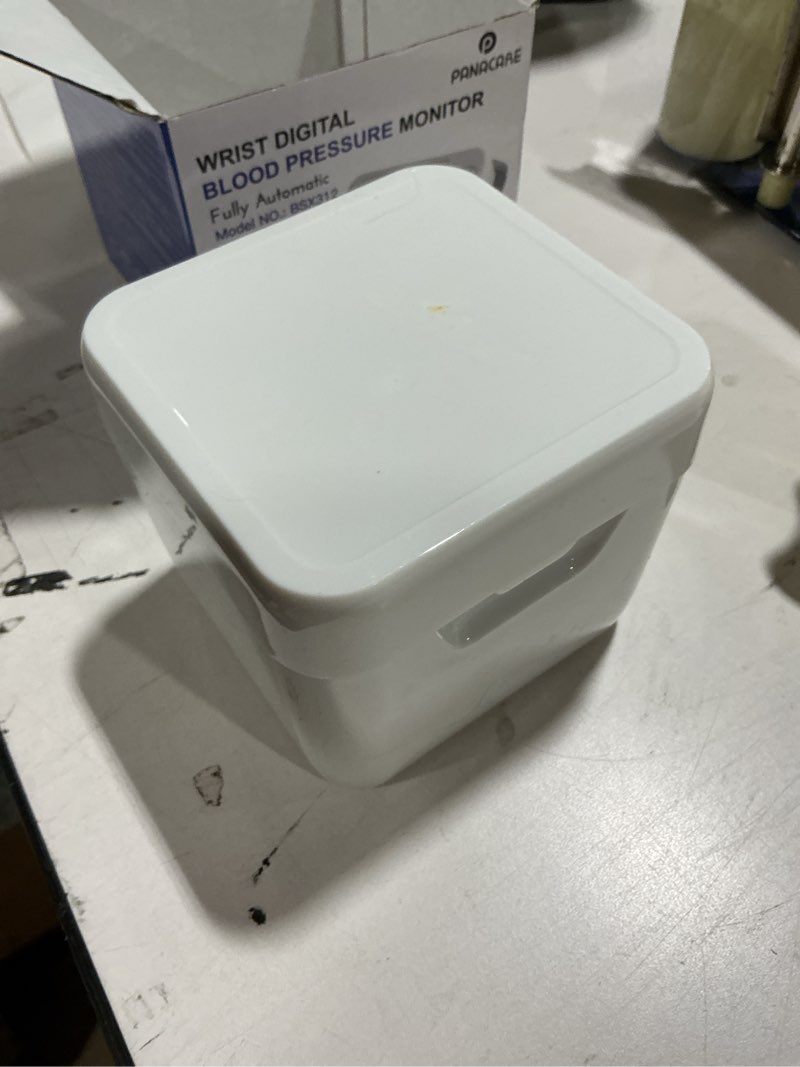 Condition photo showing As Is for wrist blood pressure monitor for home use, large lcd backlit display, portable and lightweight, 298 memory storage for 2 users with carrying case