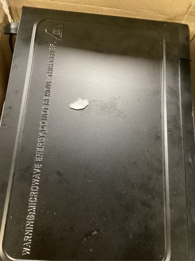 Condition photo showing As Is for mainstays 0.7 cu ft countertop microwave oven, 700 watts, black
