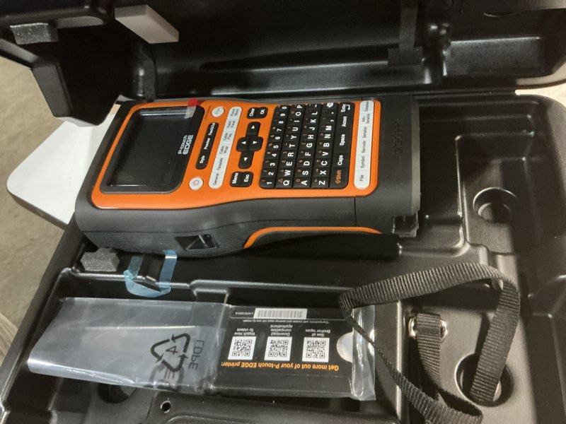 Condition photo showing As Is for brother pt-e560btvp p-touch edge handheld industrial label printer with bluetooth and dual auto-cutter (up to 24mm labels) pt-e560bt kit + 1 tape