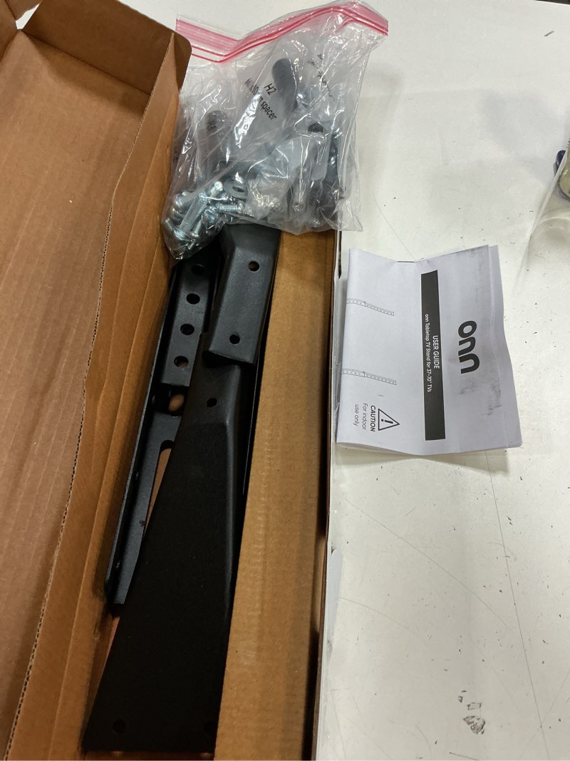 Condition photo showing As Is for onn tabletop tv stand for 37" to 70" tvs, holds up to 110 lbs, black- metal legs for tabletop