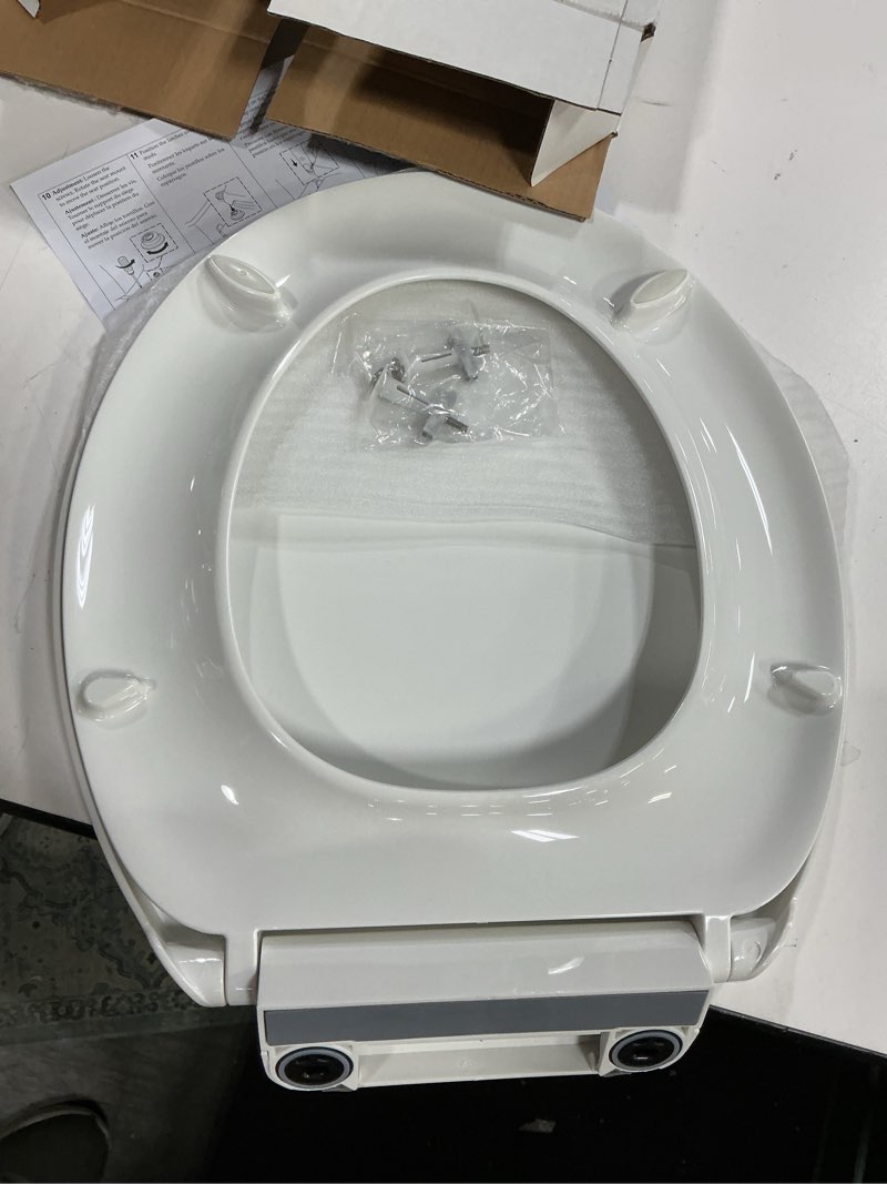 Condition photo showing New/Like New for kohler k-27332-0 glissade readylatch quiet close round toilet seat, white, grip-tight hardware, quiet close lid prevents slamming white round