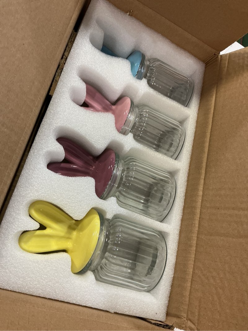 Condition photo showing New/Like New for easter decorations - 4 pack glass candy jars with ceramic bunny ear lids, easter bunny table decor for chocolate mini eggs sweets - 250ml pastel colored jars