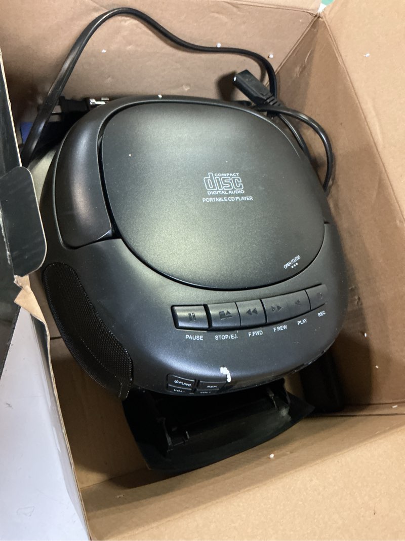 Condition photo showing As Is for klim cd player & cassette tape player with case, bluetooth boombox, am/fm radio, stereo sound, remote, cd and cassette combo, tape recording, usb drive, aux, ac/dc powered