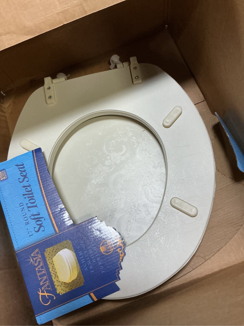 Condition photo showing As Is for soft standard vinyl toilet seat, bone - 17 inch soft vinyl cover with comfort foam cushioning - fits all standard size fixtures - easy to install fantasia by achim home decor bone 17 inch vinyl
