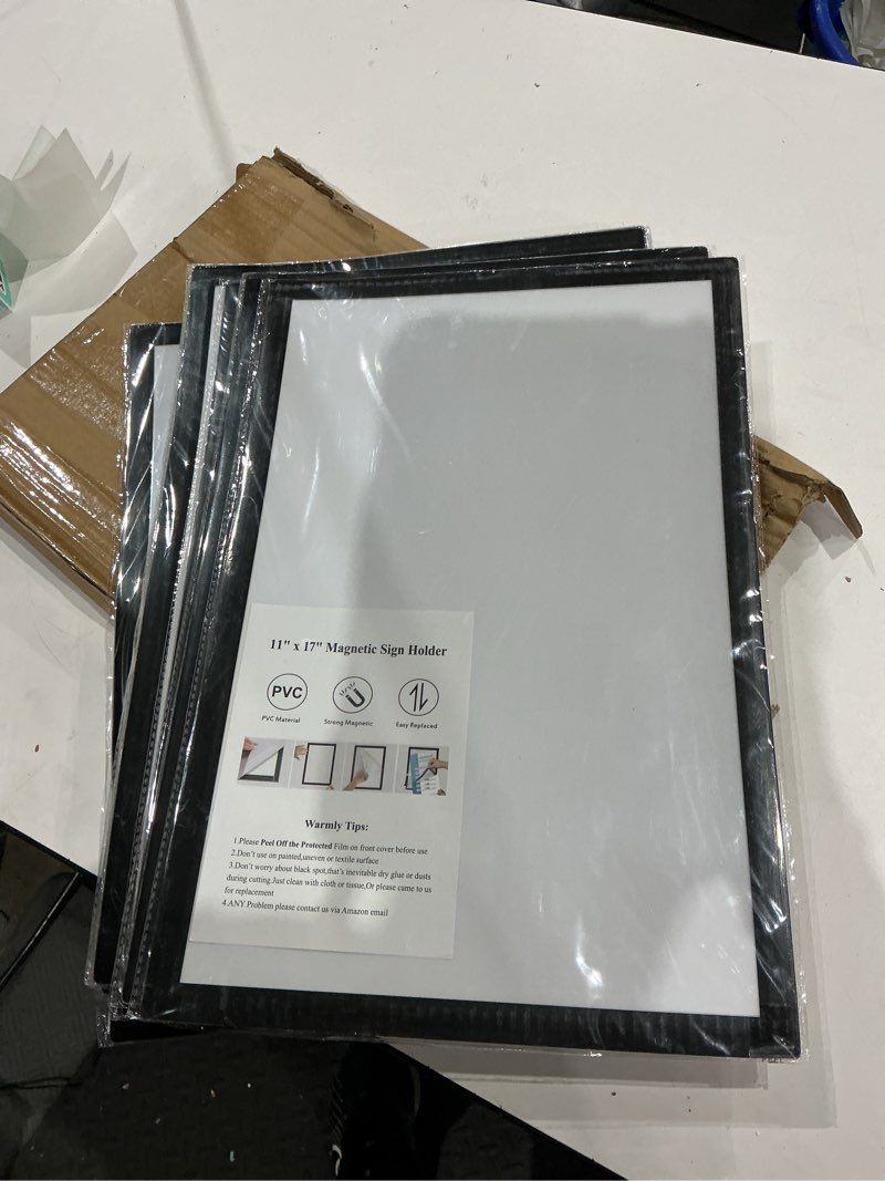 Condition photo showing As Is for 11"x 17" self adhesive magnetic sign holder, double sided window magnetic display frame, peel and stick picture frames for office/home/store/door/glass/wall display (black,10pack) black 11"x17" 10pack