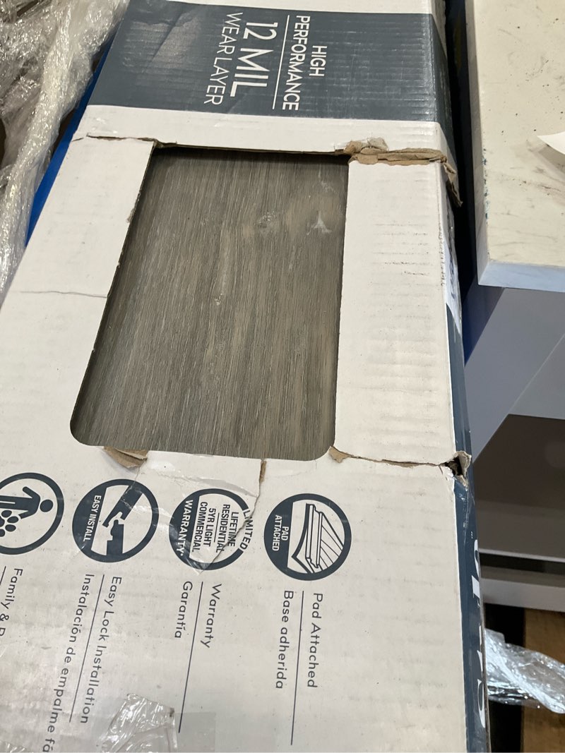 Condition photo showing As Is for  style selections charleston oak 12-mil x 7-in w x 48-in l waterproof luxury vinyl plank