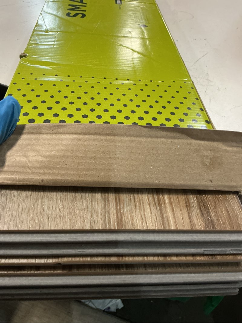 Condition photo showing As Is for smartcore by coretec floors burbank oak brown 20-mil x 7-in w x 48-in l waterproof interlocking luxury vinyl plank flooring (16.54-sq ft/ carton)