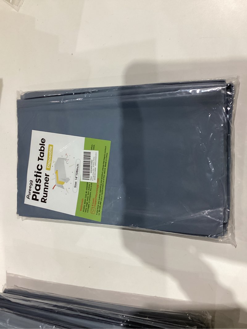 Condition photo showing New/Like New for Pureegg Dusty Blue Plastic Table Runners - 20 Pack, 14'' x 108'', Water Resistant & Disposable Centerpiece Decorations for Table Cloth, Wedding, Birthday, Holiday, Baby Shower, Party, Home Decor Dusty Blue 20 Pack – 14" x 108"
