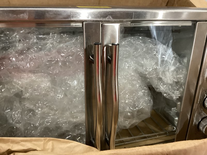 Condition photo showing Good Condition for elite gourmet eto4510b# french door 47.5qt, 18-slice convection oven 4-control knobs, bake broil toast rotisserie keep warm, includes 2 x 12" pizza racks, stainless steel 18-slice, 45l w/ rotisserie stainless steel and black