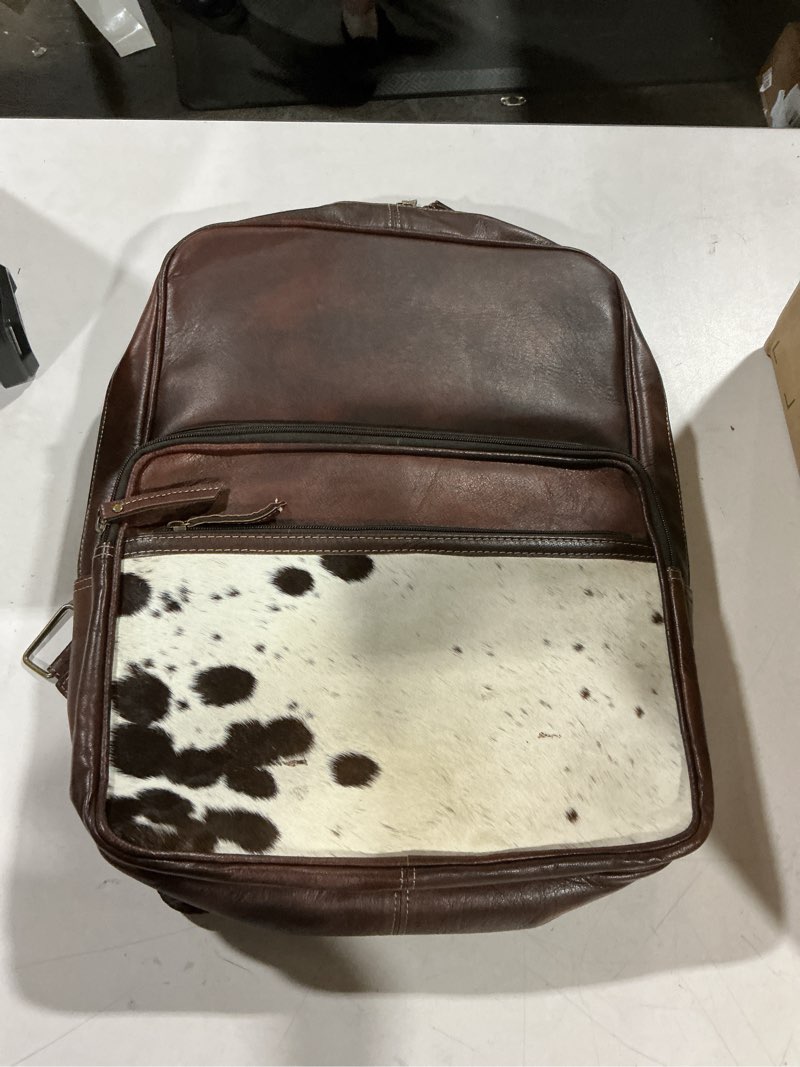 Condition photo showing As Is for cowhide western leather laptop backpack for men & women - stylish college teacher purse dark brown & white genuine leather bag for travel & office use - dimensions: (12 x 4 x 16 inches)