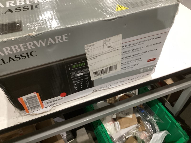 Condition photo showing As Is for Farberware 0.7 Cu. Ft. Countertop Microwave Oven – 700 Watts Power, Auto Cook Settings, Defrost, Easy Clean and Child Safety Lock - Black 0.7 Cu. Ft Black