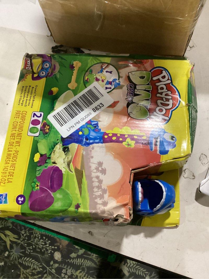 Condition photo showing As Is for play-doh dino crew growin' tall bronto toy dinosaur for kids 3 years and up with 2 eggs, 2.5 ounces each, non-toxic standard packaging