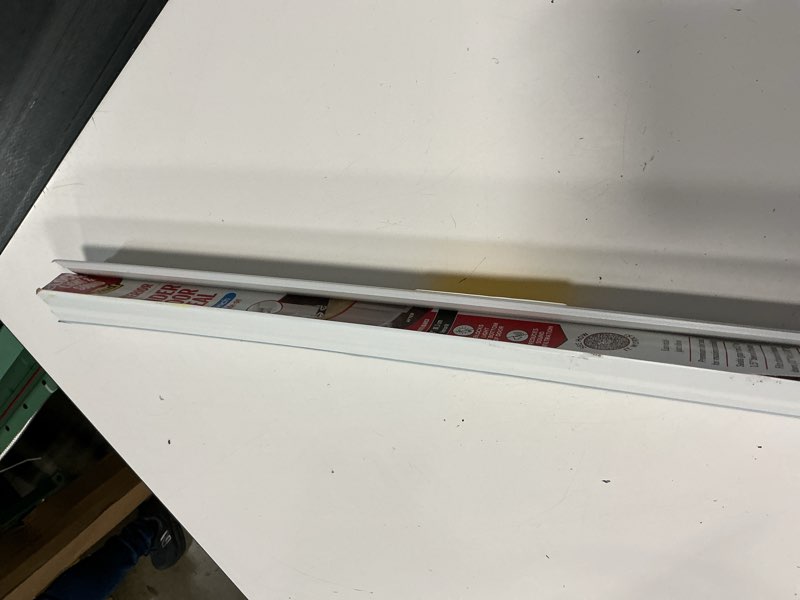 Condition photo showing As Is for m-d building products 32 in. white vinyl & rubber cinch slide-on interior light & sound under door seal