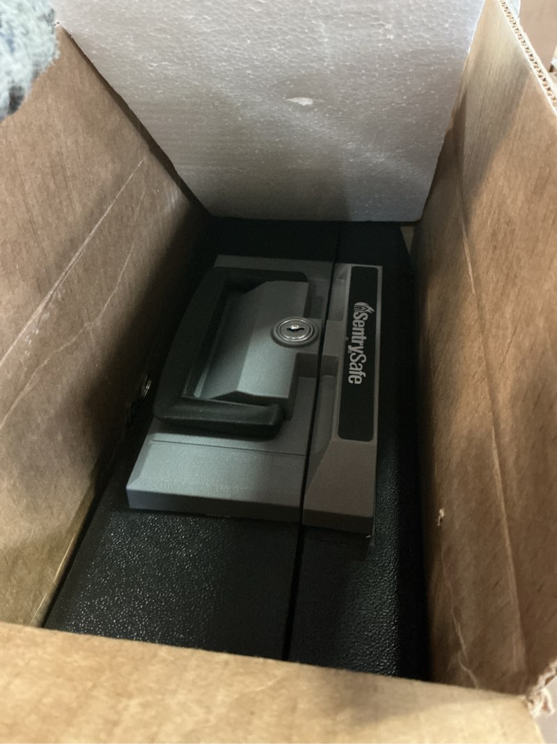 Condition photo showing Good Condition for sentrysafe fireproof safe box with key lock, chest safe with carrying handle to secure money, jewelry, documents, 0.25 cubic feet, 6.3 x 15.3 x 12.1 inches, 1160 fire resistant box 0.25 cu. ft.