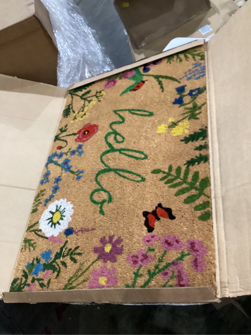 Condition photo showing As Is for calloway mills az105992436 floral hello doormat, 24" x 36", multicolor hello 2' x 3' (rectangular)