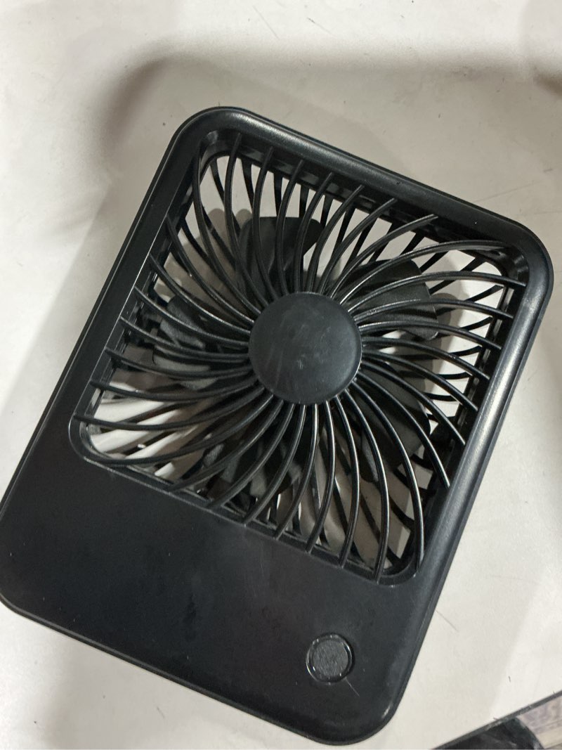 Condition photo showing As Is for mainstays new 4-inch 3-speed portable rechargeable foldable fan with lighted power button  white