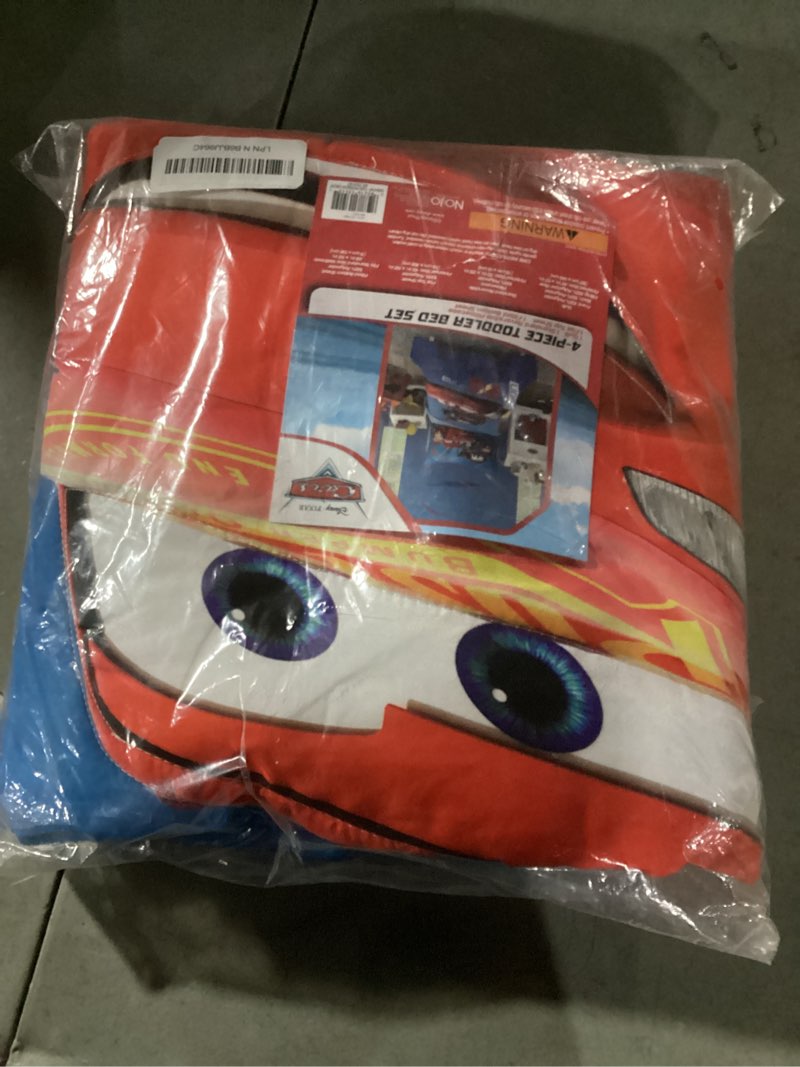 Condition photo showing New/Like New for Disney Cars Piston Cup Circuit Blue, Red, and Yellow, Lightning McQueen and Mater 4 Piece Toddler Bed Set - Comforter, Fitted Bottom Sheet, Flat Top Sheet, and Reversible Pillowcase