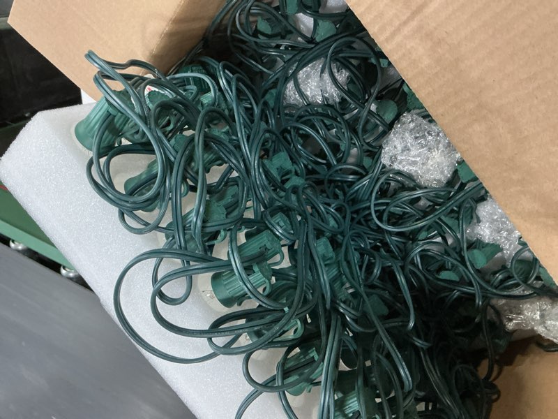 Condition photo showing Good Condition for C9 Clear Christmas String Lights, 100 Feet Waterproof Vintage Christmas Tree Lights, Outdoor Roofline String Lights with 100 Clear Bulbs for Patio Garden Holiday Indoor Home Decoration, Green Wire 100FT Clear Bulb Green Wire