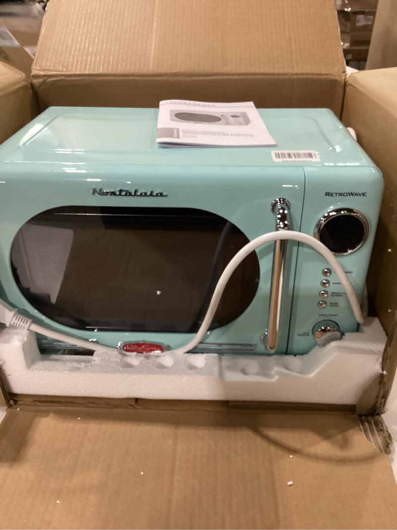 Condition photo showing As Is for not tested ***nostalgia countertop microwave oven with easy clean interior - retro microwave with led display & child lock- compact 0.7 cu. ft. oven with 12 pre-programmed settings for quick cooking- 700-watts-aqua retro classic 0.7 cu. ft. aqua