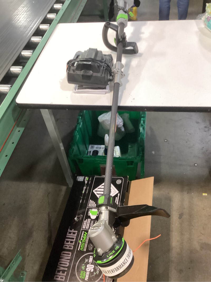 Condition photo showing As Is for ego power+ line iq with powerload st1623t 16 in. 56 v battery string trimmer kit (battery & charger) w/ telescopic shaft & 4.0 ah battery