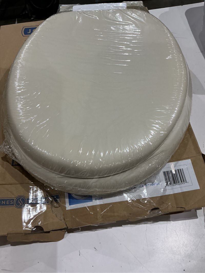 Condition photo showing New/Like New for mayfair padded toilet seat, cushioned soft vinyl over wood core seat, secure hinges, easy clean, made in usa, round, bone