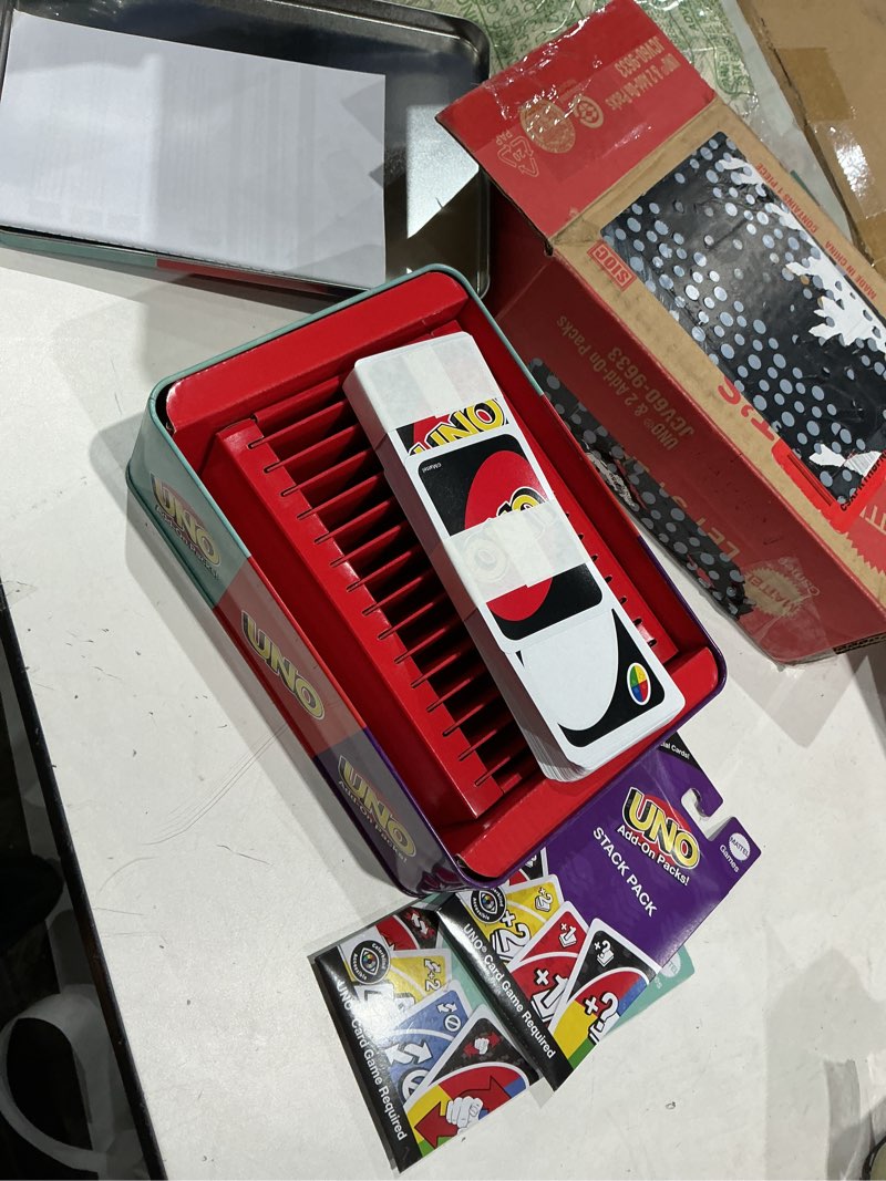 Condition photo showing Good Condition for mattel games uno card game with 2 add on packs & collectible tin for kids, adults & family game night. 2 to 10 players (amazon exclusive) uno w/add-on reverse + stack packs