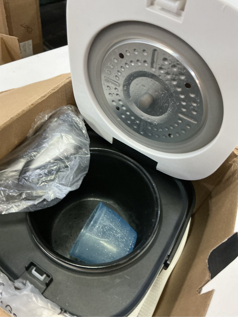 Condition photo showing As Is for rice robot personal rice cooker, pfas-free, nonstick. 1 quart capacity, with stainless steel steamer tray, measuring cups, recipe book with 60 recipes, and serving spoon, as seen on tv
