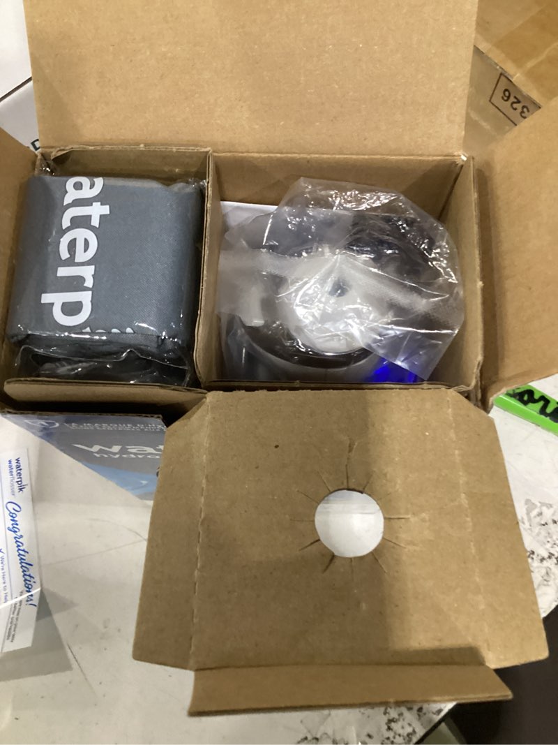 Condition photo showing As Is for waterpik cordless advanced 2.0 water flosser for teeth, gums, braces, dental care with travel bag and 4 tips, ada accepted, rechargeable, portable, and waterproof, white wp-580, packaging may vary