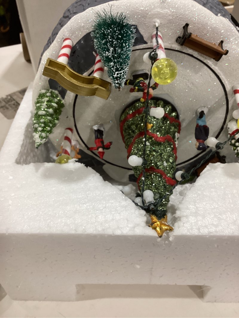 Condition photo showing Good Condition for Christmas Village Ice Skating Rink Animated Decorations, Lighted Musical Winter Snow Village Building Figurine with Christmas Tree and Skaters, LED Light Up Holiday Indoor Town Decor Skiing