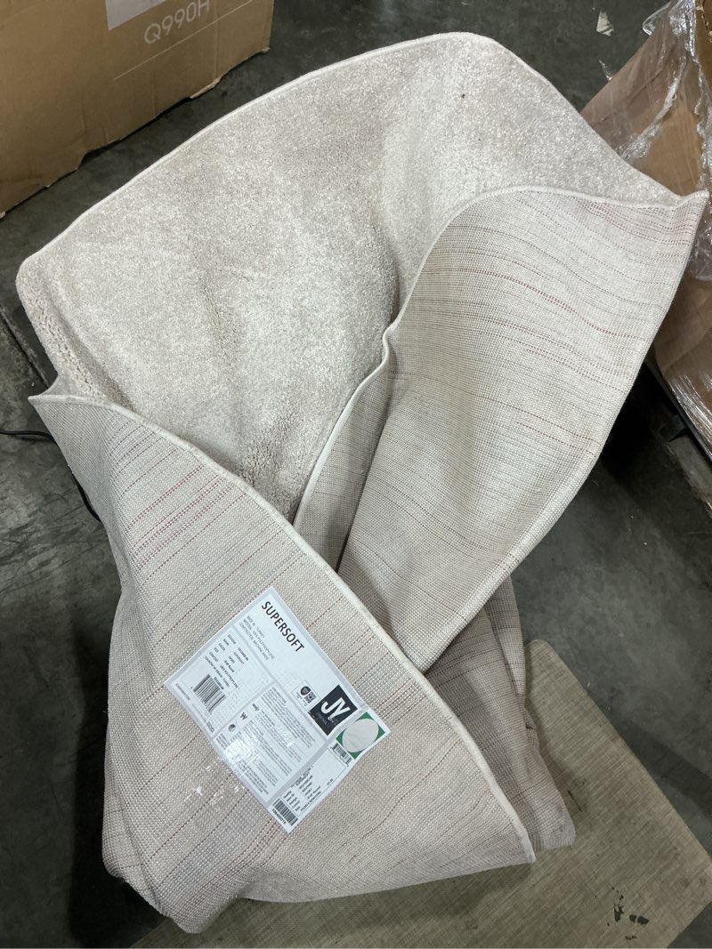 Condition photo showing As Is for jonathan  y supersoft haze solid low-pile 8 x 8 (ft) ivory round indoor solid coastal area rug