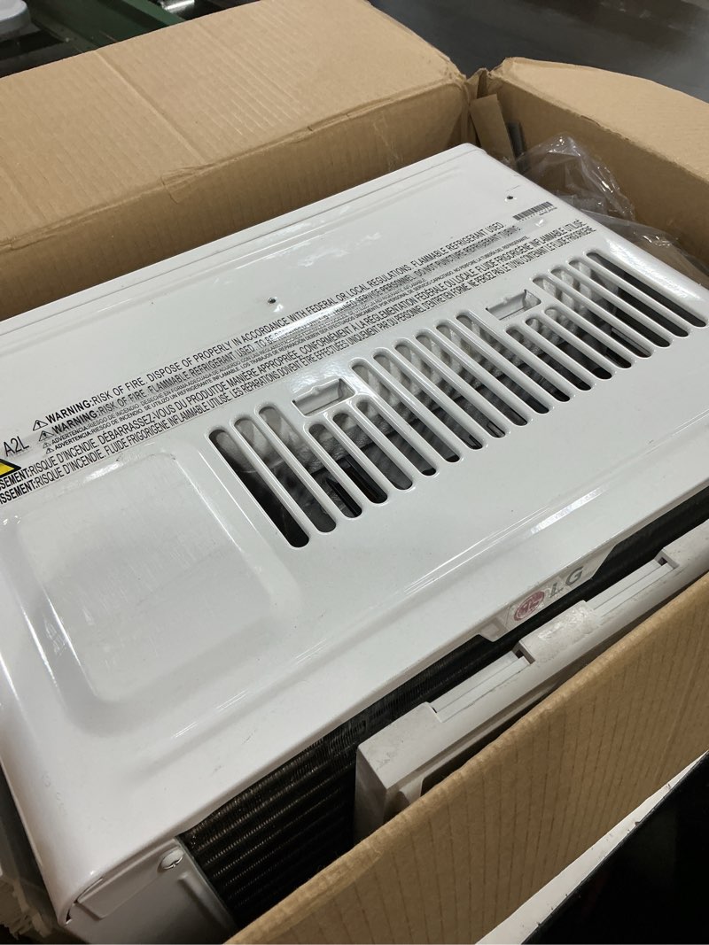Condition photo showing As Is for lg 6,000 btu window air conditioner, cools 250 sq.ft. (10' x 25' room size), quiet operation, electronic control with remote, 2 cooling & fan speeds, 2-way air deflection, auto restart, 115v 6000 btu electronic & standard bright white