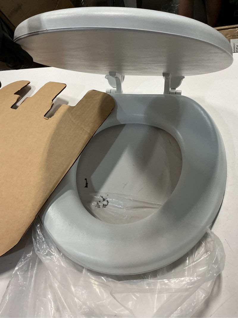 Condition photo showing As Is for mayfair padded toilet seat, cushioned soft vinyl over wood core seat, secure hinges, easy clean, made in usa, round, white round white toilet seat