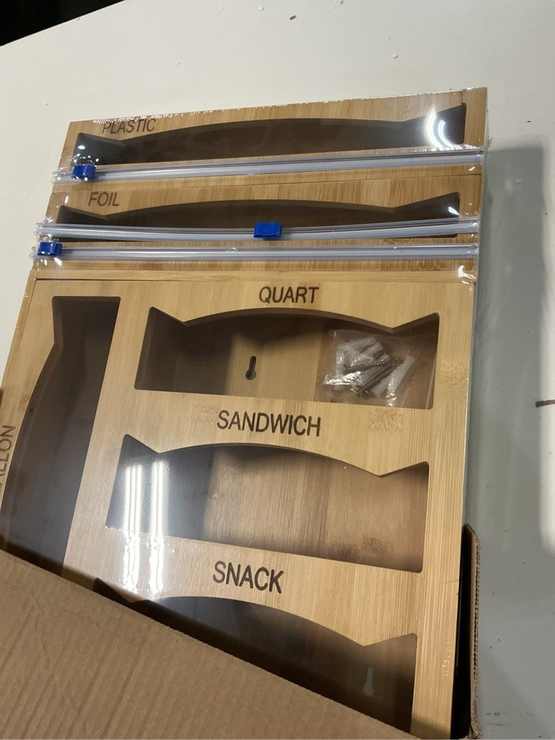 Condition photo showing New/Like New for 6 in 1 storage bag organizer kitchen drawer, bamboo foil and plastic wrap dispenser with slider cutter, kitchen bag organizer for quart, gallon, sandwich and snack bags natural bamboo