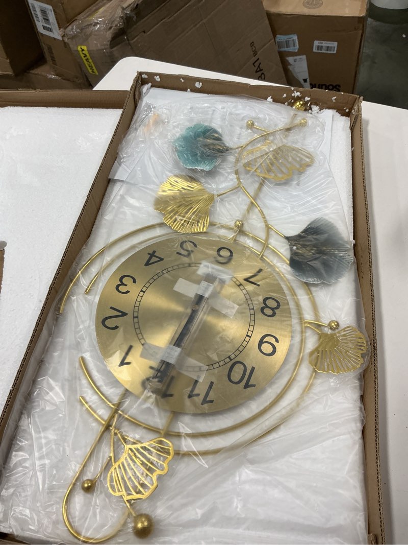 Condition photo showing New/Like New for FILLOVE Elegant Metal Wall Clock with Silent Round dial and Gold and Blue Leaves, Modern Non-Walking Silent Metal Wall Clock for Living Room, Bedroom, Study, Office (25in*12in) (Gold Leaf)