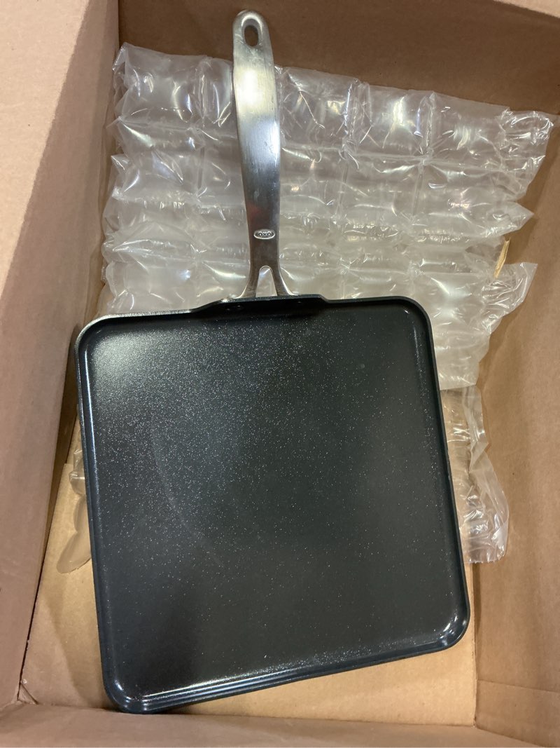 Condition photo showing As Is for oxo enhanced 11" griddle pan, pfas-free ceramic nonstick, durable hard anodized cookware, scratch resistant, stainless steel handle, good grips, dishwasher safe, oven safe, black