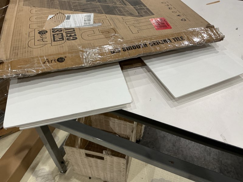 Condition photo showing As Is for art3d 24"x24" smooth drop ceiling tiles (48 sq.ft), 12-pack 2ft x 2ft pvc tiles for home and office, waterproof and reusable plastic ceiling, white white 24" x 24" 12pcs