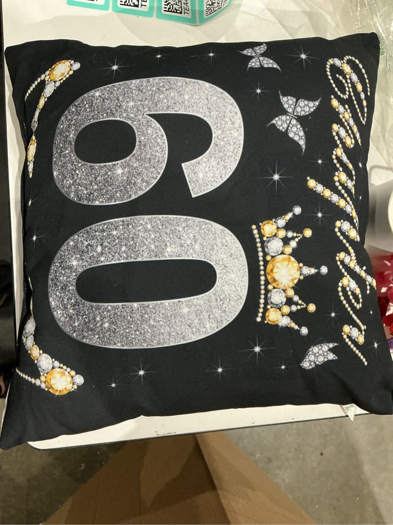 This product is a black decorative pillow featuring a glittery silver \\\"60\\\" design accented with diamond-like patterns, suitable for a 60th birthday celebration.