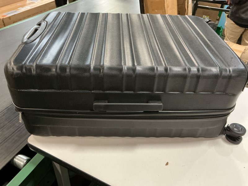 Condition photo showing As Is for Amazon Basics 30" Hardside Large Checked Luggage, Hardshell Suitcase With Wheels, Expandable For Up to 15% More Space, With Scratch-Resistant Surface, Four Multi-directional Wheels, Black Black Large Checked