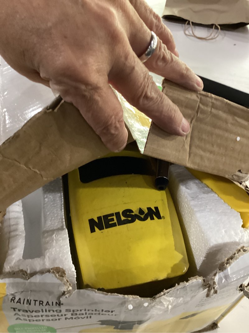 Condition photo showing Good Condition for nelson rain train 13,500 square feet cast iron outdoor lawn traveling water sprinkler for yard, and garden, with auto shut off, yellow