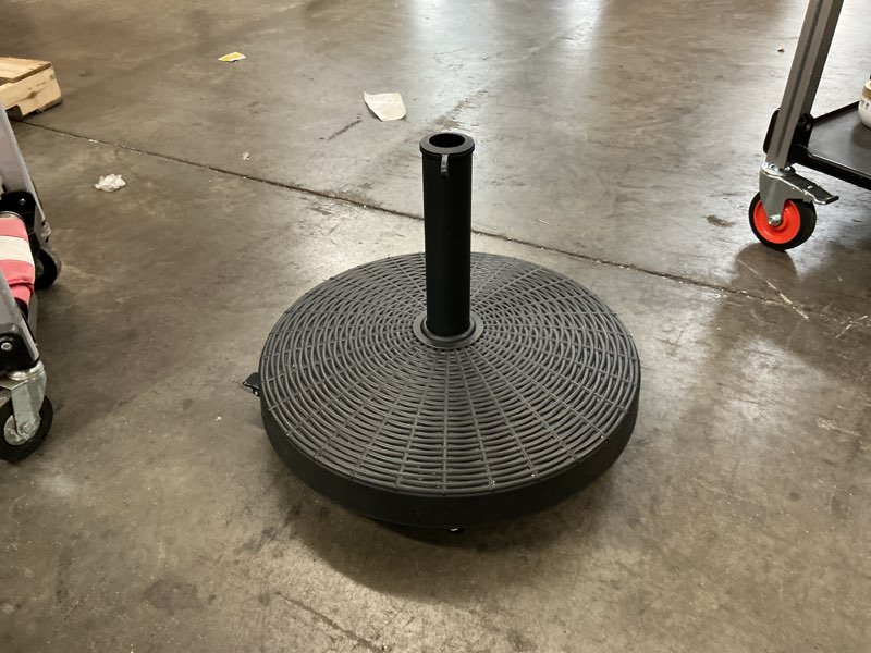 Condition photo showing As Is for 50 lbs. 20.5 in. wicker style resin heavy-duty patio umbrella base stand in black with 4 lockable wheels and hand knob