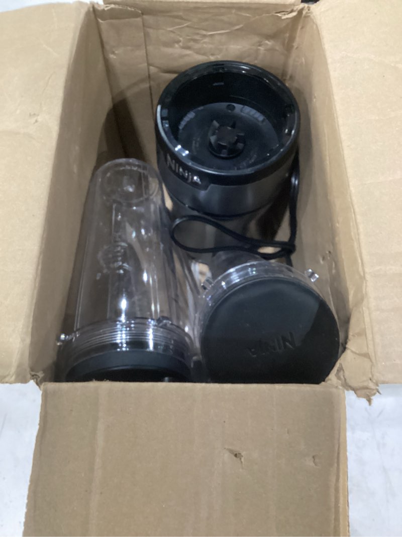 Condition photo showing As Is for ninja bn301 nutri-blender plus compact personal blender, 900-peak-watt motor, frozen drinks, smoothies, sauces & more, (3) 20 oz. to-go cups, (2) spout-lids (1) storage-lid, dishwasher safe, silver push to blend + 3 cups