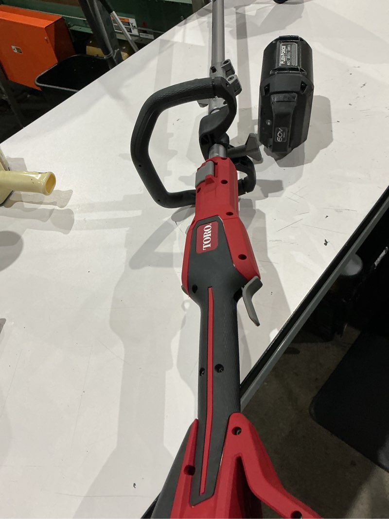 Condition photo showing As Is for toro flex-force 60-volt max 16-in straight shaft attachment capable battery string trimmer edger conversion capable 2.5 ah (battery included) (charger included)
