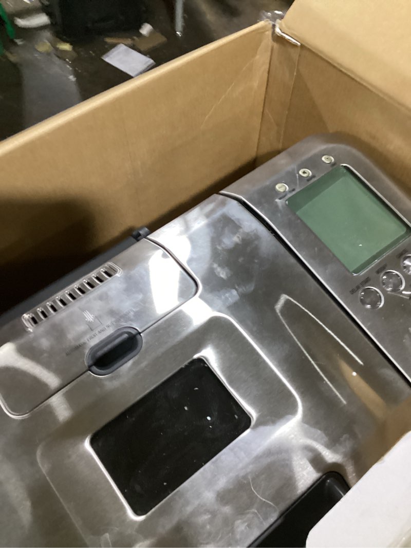 Condition photo showing As Is for cuisinart bread maker machine, stainless steel automatic bread machine with 12 menu options, 3 loaf sizes up to 2 lb., 3 crust colors, removable nonstick baking pan & kneading paddle, cbk-110nas
