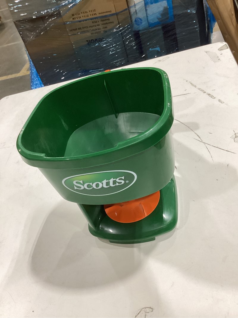 Condition photo showing As Is for scotts whirl hand-powered spreader - for grass seed, lawn fertilizers, salt, and ice melt, handheld spreader holds up to 1,500 sq. ft. of product
