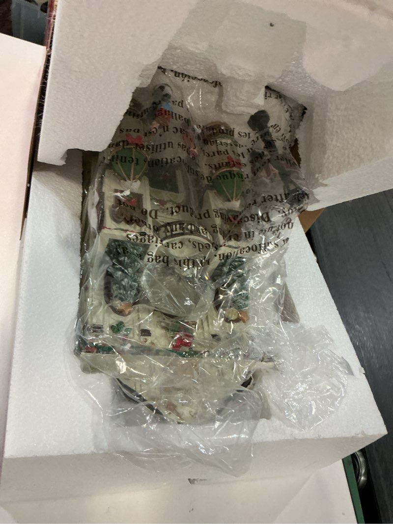 Condition photo showing As Is for MOMENTS IN TIME Fine Jewelry Shop11”H Lighted Christmas Village Building with LED Lights & Christmas Music Hand-Painted Polyresin Holiday Décor Power Adapter Included Gift Ready Display Piece