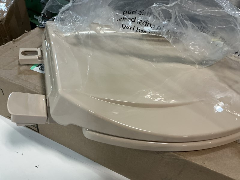 Condition photo showing As Is for 2q1e6-30 deluxe slow close plastic toilet seat with vari adjust lok-down r'n'c hinge and quik-lok mounting hardware, elongated, fawn beige