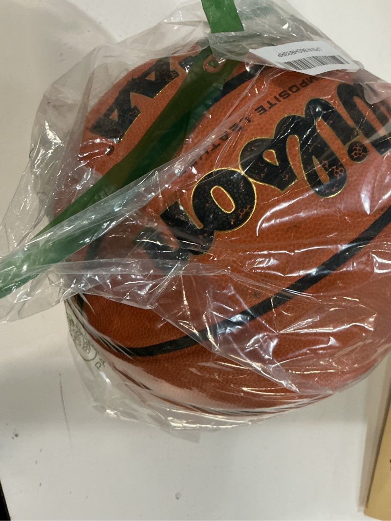 Condition photo showing As Is for wilson ncaa replica basketball - size 6-28.5" size 7 - 29.5"