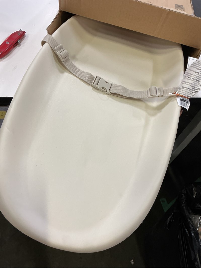 Condition photo showing As Is for skip hop baby changing pad nursery style wipe-clean contoured with cushioned foam, non-skid base, built-in safety belt & tuck-away toy bar fits standard changing tables, oat 16" oat